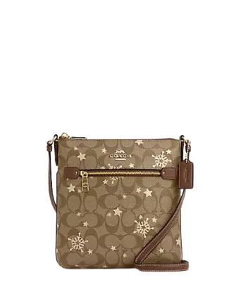 Coach bags with a front - flap pocket and a turnlock for a classic aestheticCoach Mini Rowan File Bag In Signature Canvas With Star And Snowflake Print