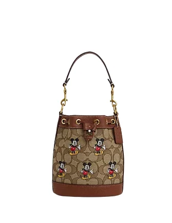 Coach tote bags with a printed Coach logo for brand visibilityCoach Disney X Coach Mini Dempsey Bucket Bag In Signature Jacquard With Mickey Mouse Print