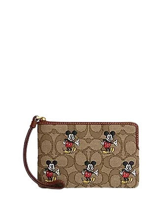 Coach tote bags with a snap - button closure and a decorative charm for styleCoach Disney X Coach Corner Zip Wristlet In Signature Jacquard With Mickey Mouse Print